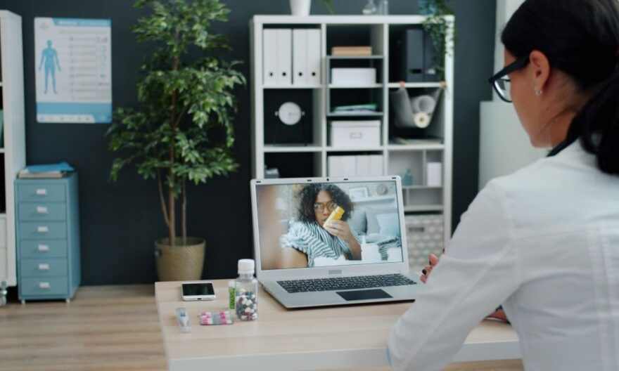 Healthcare professional having virtual appointment with patient on laptop. - Photo by Vitaly Gariev on Pexels