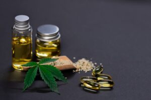 Assorted cannabis products including hemp seeds, oil, and capsules on dark background. - Photo by Kindel Media on Pexels